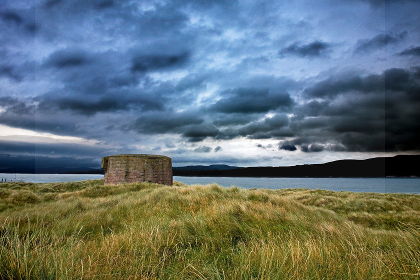 Martello Tower Lough Foyle N Ireland 
 A Martello Tower in grassy sand dunes at Magilligan Point at the head of Lough Foyle, Londonderry, Northern Ireland. dranatic sky 
 Keywords: martello, tower, Northern Ireland, Foyle, lough, loch, coast, Magilligan, point, sramatic, sky, clouds, dunes, sand, grass, brick, defence