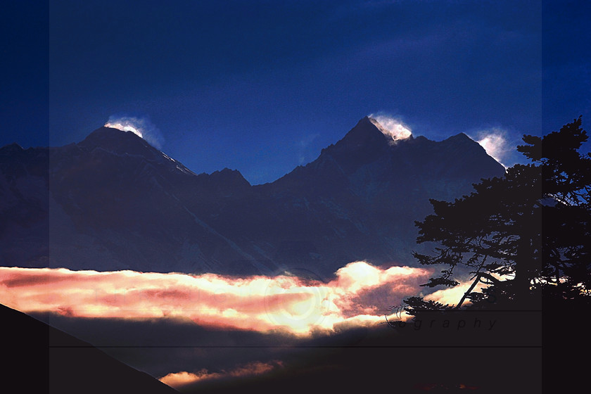 Everest sunset - at 15000ft 
 6pm - at the end of a long day's trek to Tyangboche monastery, the clouds below Everest burned red and gold as the sunlight disappeared beneath the mountains. 
 Keywords: everest, himalaya, summit, peak, ice, glacier, snow, sky, mountain, rock, pattern, nepal, khumbu, sagarmatha, base camp, trek, sunset, cloud, dusk, Thyangboche, altitude, evening