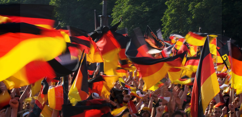 THE FANS WORLD CUP 
 Keywords: Germany, flags, crowd, celebration, fans, waving, arms, red, yellow, black, stripes, colour